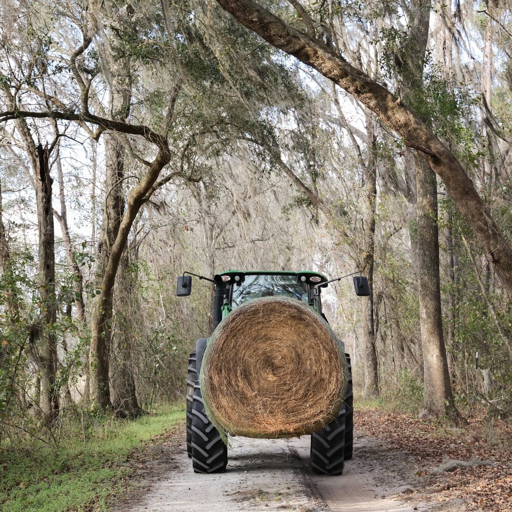 Three Oak Farm John Deere tractor with round hay bale Three Oak Farm John Deere tractor with round hay bale